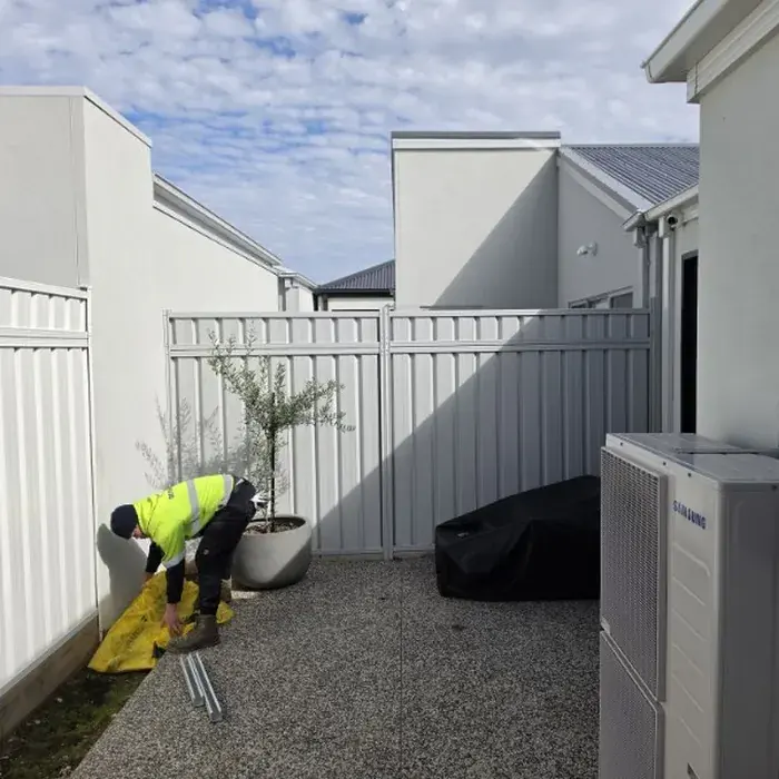 White Colorbond fence installed by Mickleham Fencing for Memet Electrical