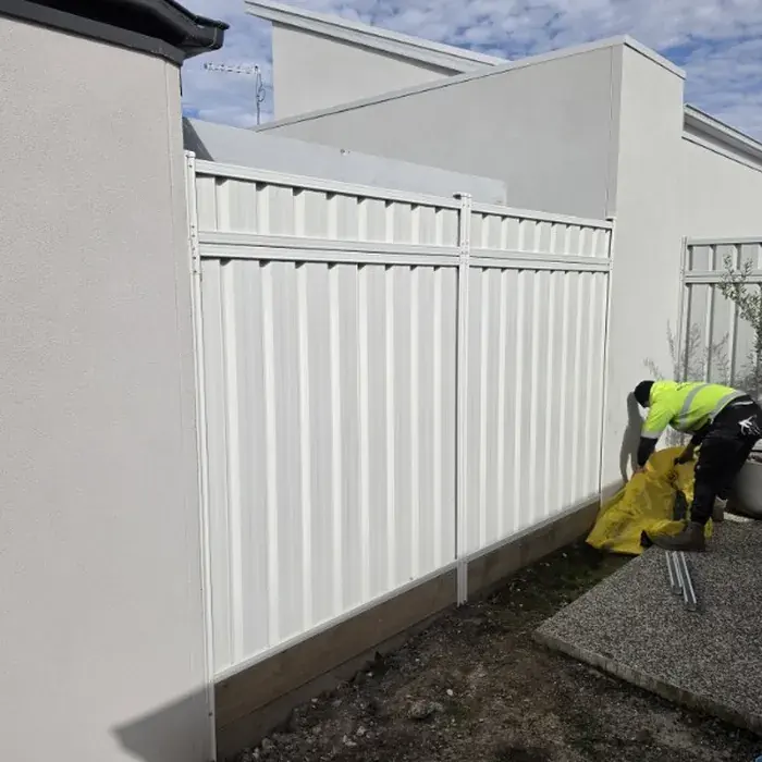 Finished white Colorbond courtyard fence for Memet Electrical