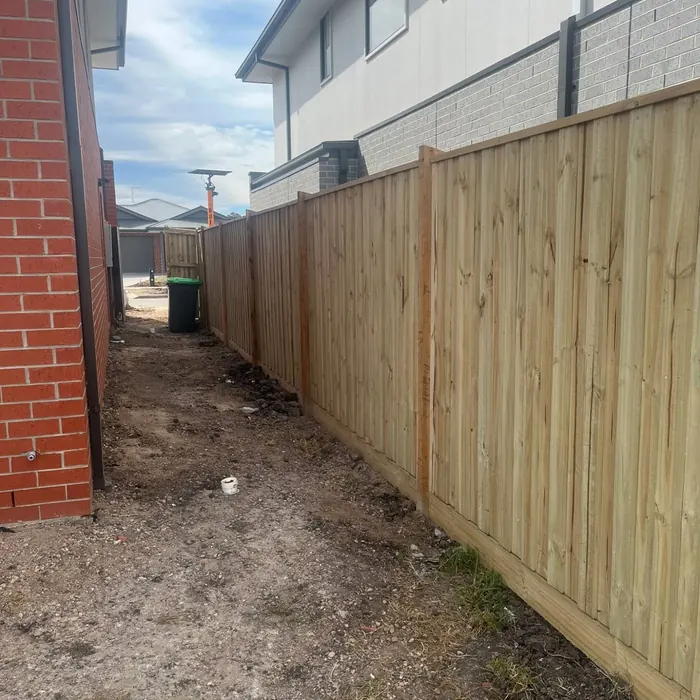 New treated pine timber paling fence along a side boundary by Mickleham Fencing