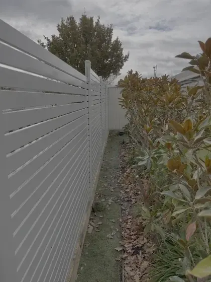 White horizontal aluminium slat side fence installed by Mickleham Fencing
